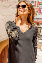 Black cotton beach dresses with gold embroidered sleeves by Lindsey Brown luxury resort wear 