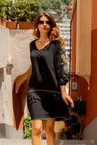 Black cotton knee length beach dress to wear on holiday by Lindsey Brown