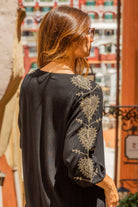 Black gold cotton beach dresses to wear on a Winter Sun holiday by Lindsey Brown