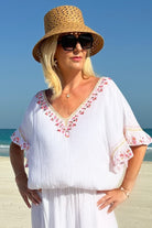 White coral designer kaftan dress to wear on holiday by Lindsey Brown resort wear 