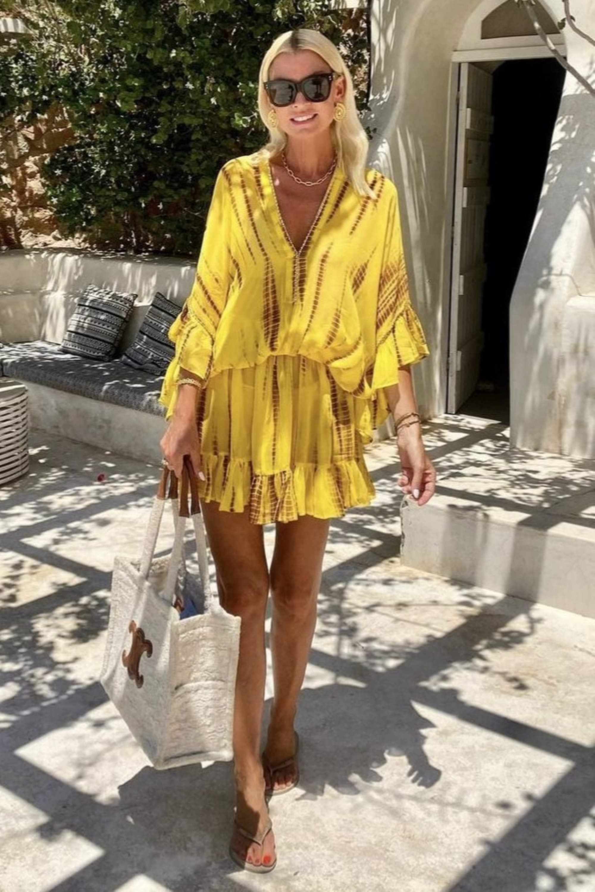 Yellow silk drop waisted silk resort wear to wear on holiday by Lindsey Brown