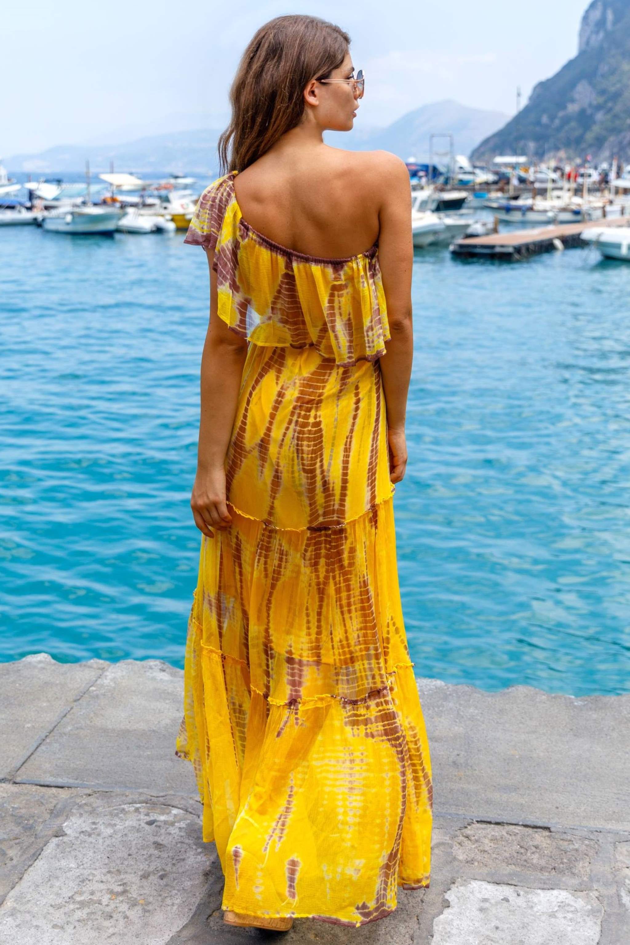 Yellow one shoulder silk maxi dress to wear on a luxury holiday by Lindsey Brown silk resort